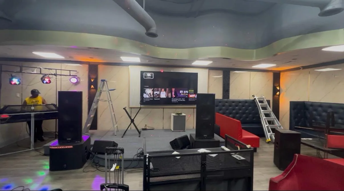 The lounge mid-buildout with ladders, staging and unfinished flooring