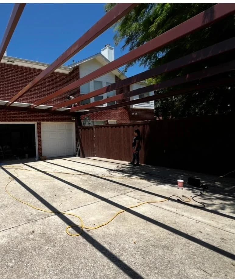The open concrete driveway with the existing timber beams overhead before the structure was built